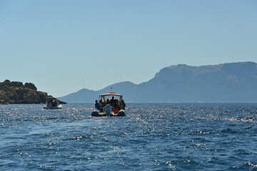 Tourist boats trips in search of wild dolphins, near Golfo Aranci, Sardinia, Italy