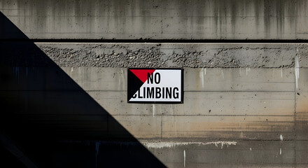 Prohibition Sign On Concrete Wall With Dramatic Shadow, Warning Against Climbing