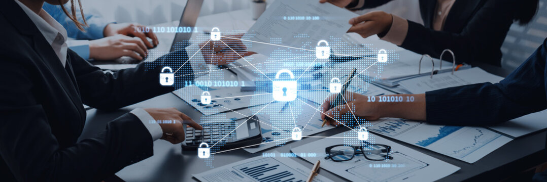 A diverse team collaborates at a modern office desk, focusing on secure digital transactions and data protection, highlighted by network security symbols and analytical documents. Trope