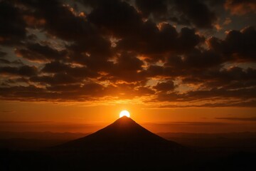 A Silhouette of a Mountain Under the Setting Sun