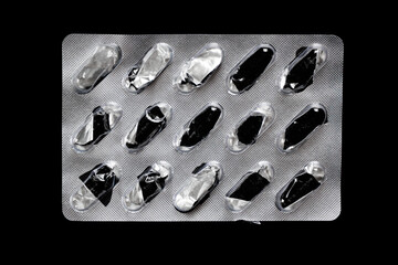 Antibiotic capsules in silver blister packaging. Macro shot of medication used in treatment, pharmacy, and clinical healthcare settings.