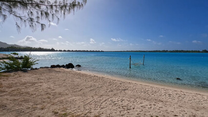 Luxury resort photos of French Polynesia tropical 
paradise island with sandy coast, azure ocean, 
sky with clouds on horizon. Pacific Ocean.