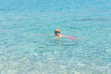 man floating in clear sea