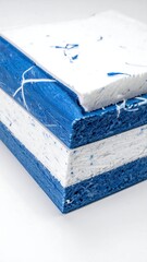 Stacked layers of colorful materials, side view on a white backdrop