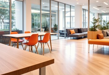 Bright modern office lounge with glass walls, warm wood floor, and orange chairs
