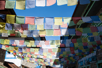 Lung ta prayer flags in the main street of Lukla, Nepal
