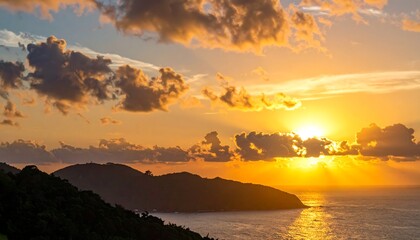 Naklejka premium Vivid orange sunset over the sea, clouds illuminated