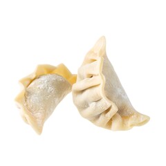 Two uncooked, semi-circular food items with crimped edges, light background