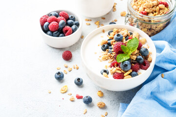 Yogurt with fresh berries in white bowl.