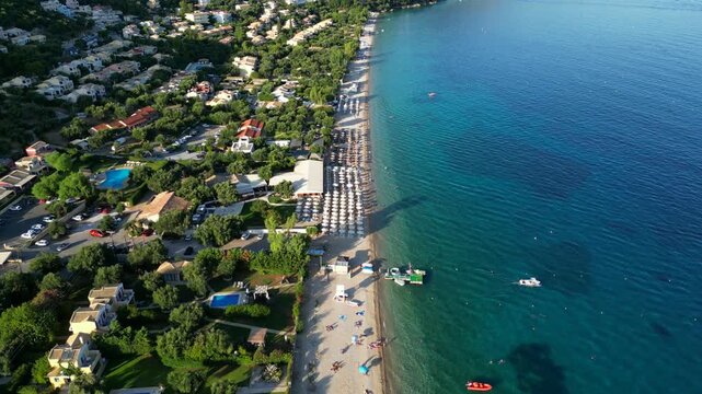 Aerial view of serene beach scene showcasing vibrant turquoise waters, sandy shore, and sun loungers, capturing the tranquil atmosphere of a coastal paradise
