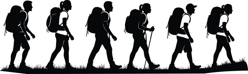 Silhouettes of hikers with backpacks walking across grassy terrain trekking