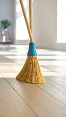 Broom on light wood floor