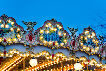 Vintage carousel lights and decorations at evening fair in Vienna