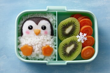 Cute penguin rice bento box with kiwi and carrot for kids