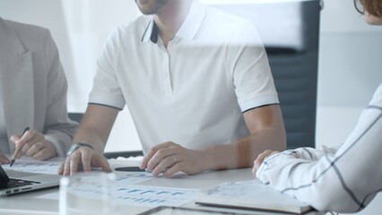 Business people team collaborating in a modern office, analyzing financial data and discussing growth strategies during an engaging and productive meeting focused on achieving success, close up