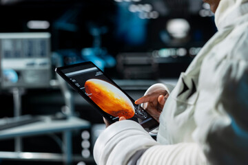 Close up of cosmonaut managing systems on device before Mars expedition. Astronaut operating spacecraft control interface, exploring red planet to support human life beyond Earth