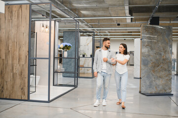 Couple shopping for home renovation tiles in showroom
