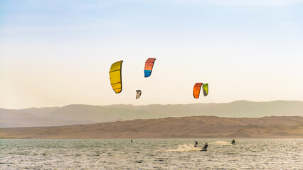 Kitesurfin in Paracas, Peru with a clear sky, summer in the beach
