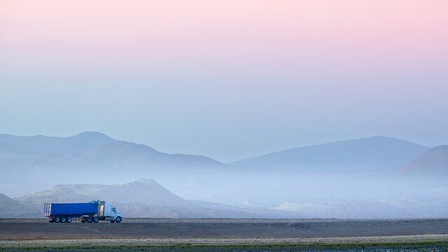 Car on the misty road at the Paracas desert 