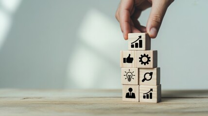 Building business strategies with wooden blocks that are engraved with different business related icons 