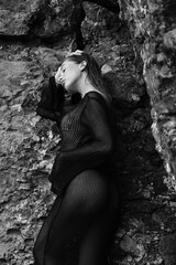 Portrait of woman in bikini on tropical beach near the mountain. Back view