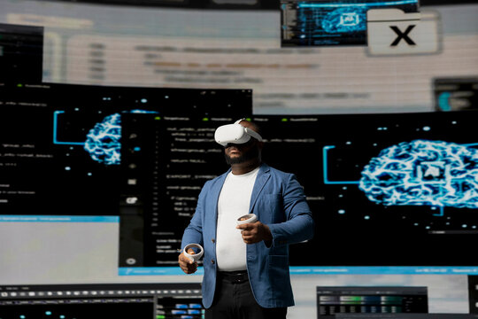 African american software technician uses virtual reality glasses and codes, high tech interface environment. Surrounded by terminal windows, represents digital workspace culture.