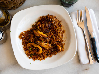 Sea paella is traditional Spanish dish, prepared using shrimp, mussels, shellfish and complemented with chicken meat. Lemon slices, spices, and light alcohol are served with food