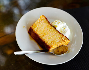 Appetizing dessert pan de calatrava served on plate with cream and topping