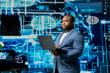 Black businessman using smart technology to interact with cybernetic platforms and AI interfaces, representing the integration of machine learning and predictive analytics in modern development.