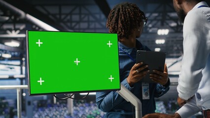 Data center colleagues working on green screen PC, updating storage infrastructure. IT engineering...