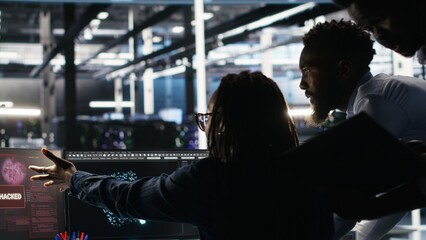 Cybersecurity team in data center responds to security breach, trying to prevent unauthorized...