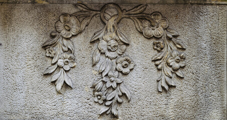 Stone wall with carved floral pattern