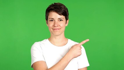 Dynamic presenter pointing to vibrant green screen for interactive presentation, ideal for explainer videos and product demos with modern appeal