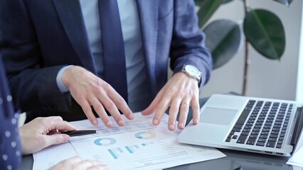 Two professionals analyzing a pie chart during a strategic business meeting. Business meeting with graph analysis