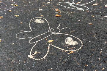Chalk Butterfly and Heart Drawings on Asphalt Path in Autumn