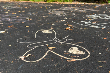 Chalk Butterfly and Heart Drawings on Asphalt Path in Autumn