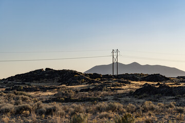 The silhouette in the distance is Big Southern Butte. Basalt (Quaternary) Lava Flows. Volcanic Field. U.S. Highway 26 (US 26) ,Idaho. Snake River Plain.  © youli zhao