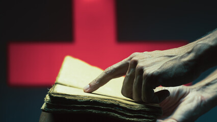 Person's hand reads an empty book on Halloween night