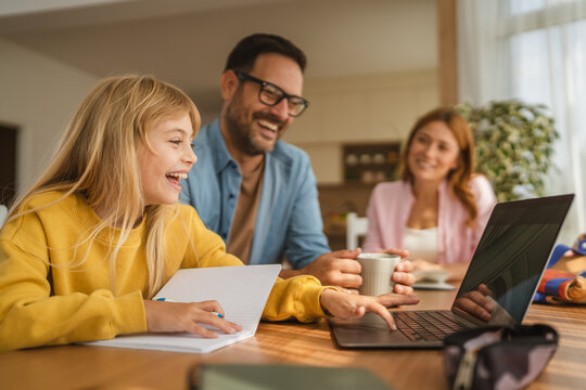 Father and daughter learning online with laptop - Powered by Adobe