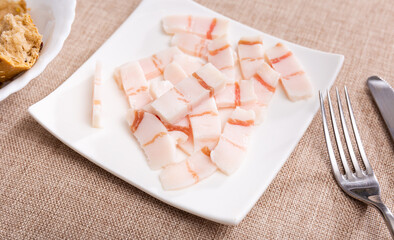 Appetizing pieces of lard served with bread at table