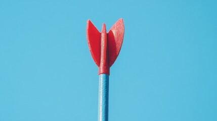 Red arrow tip against a vibrant blue sky