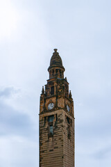 Clock tower close-up against blue sky