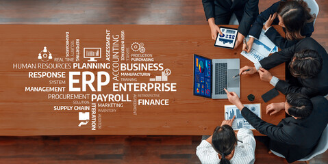 A diverse business team engaged in strategic discussions around ERP implementation, utilizing...