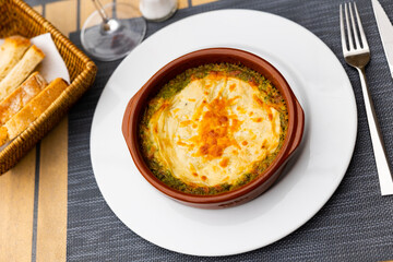 Delicious cheese lasagna with meat and spinach served on plate