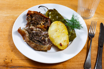 Delicious roasted lamb with potatoes and peppers served on platter