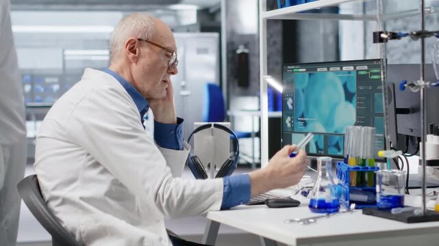Chemist in biolab observes computer with fascination and curiosity, captivating experiment data results. Intrigued scientist reading unusual biotechnology research discovery. Camera B.