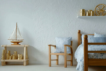 Nautical-themed bedroom with blue and white accents. Wooden bed, armchair, and dresser with a sailboat and gold decorative objects. Lifestyle and interior design.