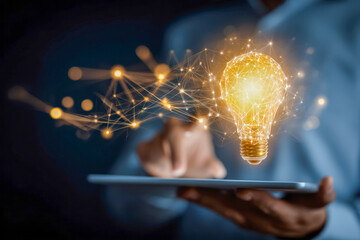 Person interacting with a digital tablet projecting a glowing network-based light bulb symbolizing innovation and creative ideas in modern technology settings