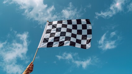Checkered flag waving over blue sky