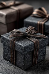 Elegant black gift boxes with ribbons on a dark background